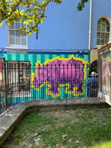 Frank-Harwood-Pink-Rhino-Glastonbury-Mural_Thorndown-Wood-Paint_2