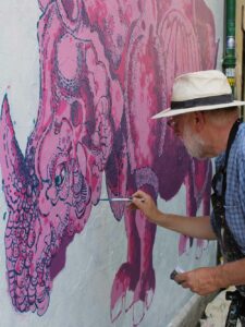 Frank-Harwood_painting-Pink-Rhino-Glastonbury-wall-mural_Thorndown-Wood-Paint